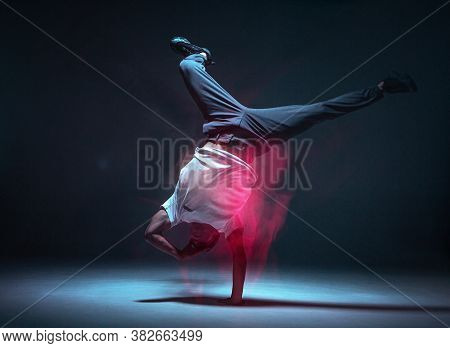 Cool Young Guy Breakdancer Dancing Hip-hop In Neon Light. Dance School Poster. Long Exposure Shot