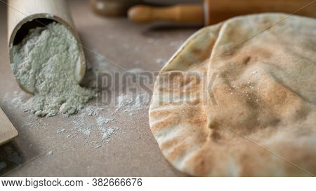 Kuboos Or Khubz - Arabic Bread On A Brown Table In The Kitchen