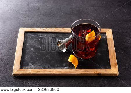 Boulevardier Cocktail And Orange Zest On Black Slate Background.copy Space