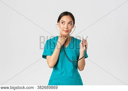 Covid-19, Healthcare Workers And Preventing Virus Concept. Cute Smiling Asian Female Intern Learn Ho