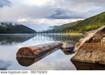Mirror Smooth Water Of The Carpathian Zetelaka Lake. Beautyful Landscape After Rain