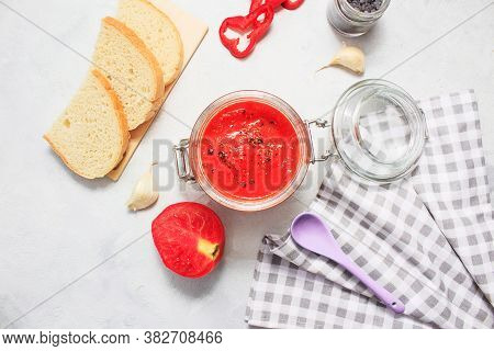 Ajvar, Pepper Mousse In A Jar And On  Bread And  Spoon On Backgground. Ajvar - Delicious Dish Of Red