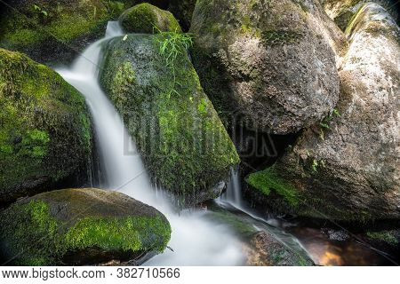 Long Exposure Of A Waterfall At Becky Falls In Dartmoor National Park