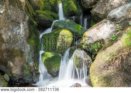 Long Exposure Of A Waterfall At Becky Falls In Dartmoor National Park