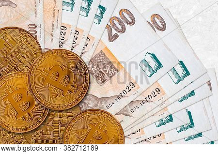 200 Czech Korun Bills And Golden Bitcoins. Cryptocurrency Investment Concept. Crypto Mining Or Tradi