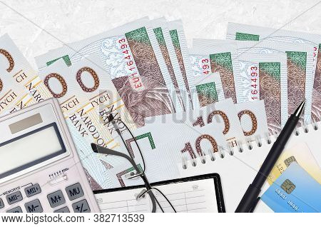10 Polish Zloty Bills And Calculator With Glasses And Pen. Tax Payment Concept Or Investment Solutio