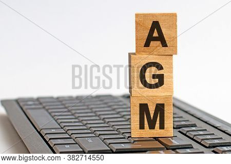 Agm Annual General Meeting Acronym On Wooden Cubes On Keyboard. Business Concept.