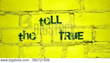 Tell The True - Words On Painted Yellow Brick Wall. News, Truth And False Business Concept