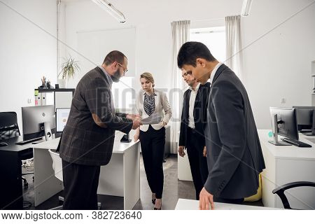 The Chief Of The Construction Company Holds A Standing Meeting With Subordinates, Gives Instructions