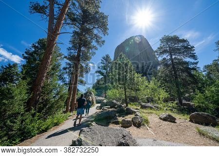 Wyoming, Usa - June 23, 2020: Tourist Hikers Walk Towards Devils Tower National Monument In The Morn