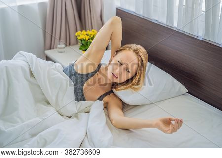 Upset Young Woman Lying In Bed In Morning Feels Pain In Neck After Night Sleep, Awaken Having Painfu