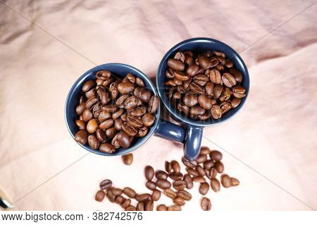 Ceramic Cup With Roasted Coffee Beans On A Table