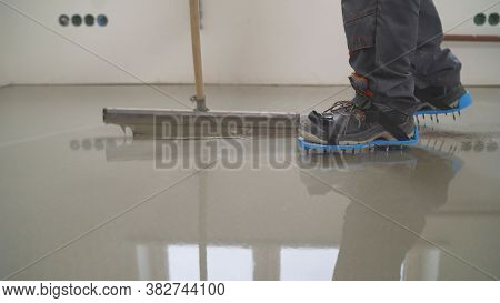 Interior Of Apartment Under Construction. Mirror Smooth Surface Of The Floor. Floor Covering With Se
