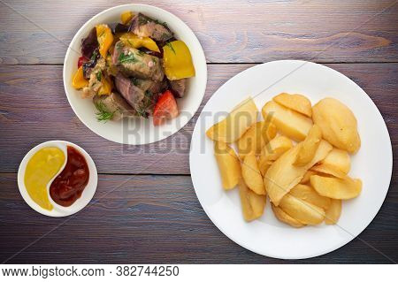 Fry Potatoes With Vegetable Salad On A Pueple Wooden Background. Fry Potatoes On A White Plate
