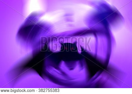 Silhouette Of A Mystical Bat On A Purple Background With A Radial Blur. Close Up