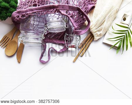 Cotton Bags, Net Bag With Reusable  Glass Jars, Bamboo And Wooden Cutlery On White Background. Zero 