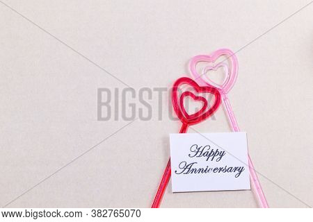 The Plastic Heart Pairs With The Happy Anniversary Card On Brown Background,valentine's Day Love Con