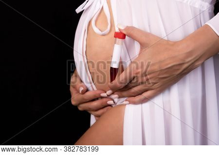 A Pregnant Girl Holds A Test Tube With Blood In Her Hands With A Place To Write The Text. Medical Co
