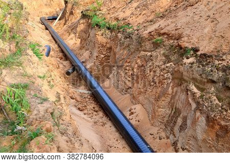 Excavated Trench To Install Gas Supply Pipework For The Power Station. Sections Of Pipe On Top Of Wo