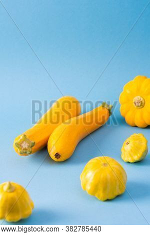 Fresh Harvest Of Zucchini And Pattypan Squash, Yellow Squash And Pattison On Blue Background