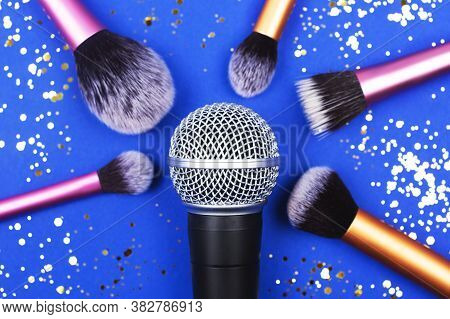 A Microphone With Many Brushes Decorated With Confetti.