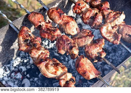 Cooking Meat On The Grill. Fried Food Over Charcoal. Barbecue Weekend. Meat Languor At Low Temperatu