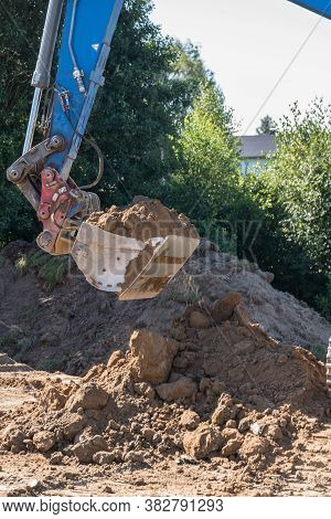 Excavator Excavating Earth On A Construction Site - Excavator Shovel
