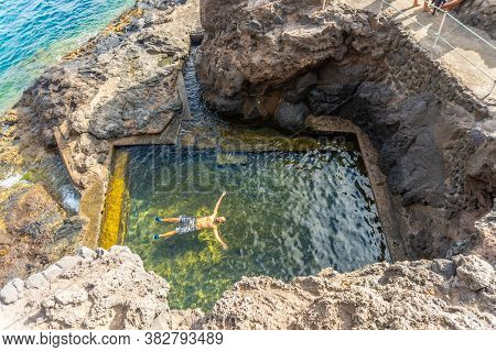 A Young Man Enjoying A Natural Sea Pool In The Cove Of Puerto De Puntagorda, Island Of La Palma, Can