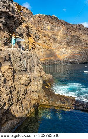 A Young Tourist In Summer From The Viewpoint Looking And Enjoying The Cove Of Puerto De Puntagorda, 