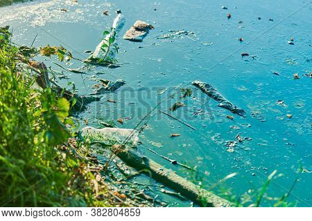 Environmental Water Pollution. Polluted River - Dirty Green Water, Garbage, Waste And Trash. Harmful
