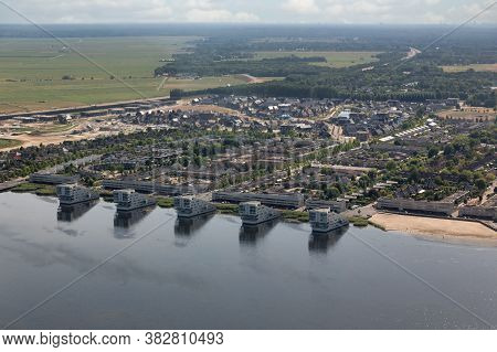 Aerial View Dutch Village Huizen At Lake Gooimeer With Apartment Buildings And Residential Area