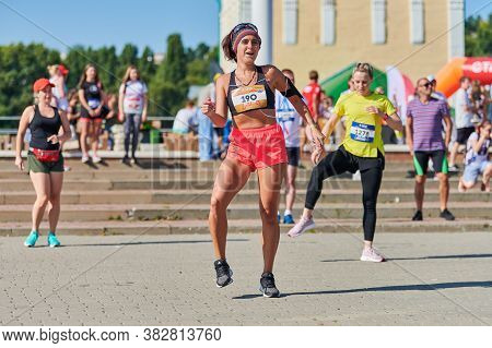Voronezh, Russia - 23.08.2019 - Young Woman Warming Up Before Running Marathon. Beautiful Girl With 