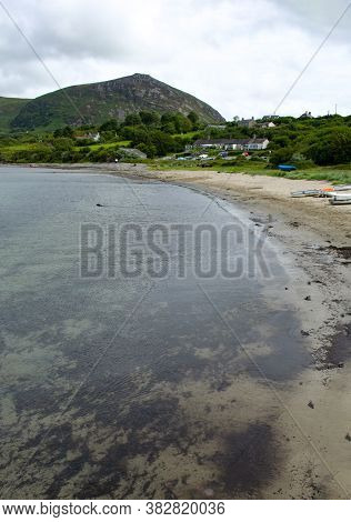 Beach Scene At Trefor In North Wales By Caernarfon.  Peaceful Landscape With A Quiet Beach In The Fo