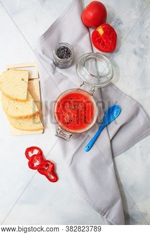 Ajvar, Pepper Mousse In A Jar And On  Bread And Blue Spoon On Backgground. Ajvar - Delicious Dish Of