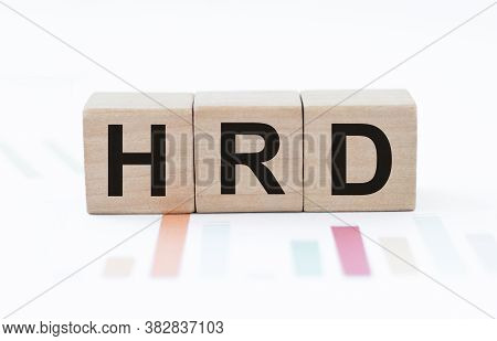 Word Hrd Made With Wood Cubes On The Background Of Colored Graphs