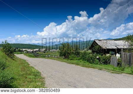 Old Russian Village In Buryatia Lying In The Tunkinskaya Valley With Mountain And Clouds In Summer D