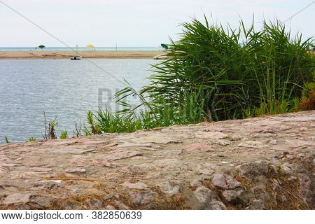 Glimpse Of Sea And River Among The Nature Of Marina Di Pisa In The Tuscan Serenity Of The Italian Su