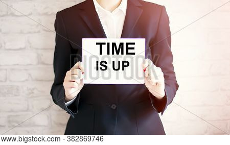 Woman Showing White Card With Time Is Up Word . Business Concept