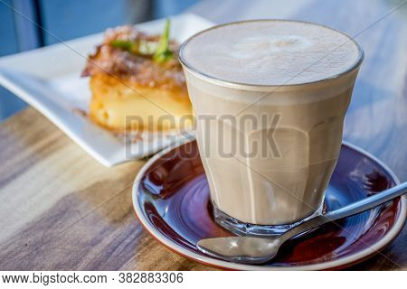 A Cup Of Coffee Latte And Delicious Greek Pastry Dessert Galaktoboureko On A Wooden Backround