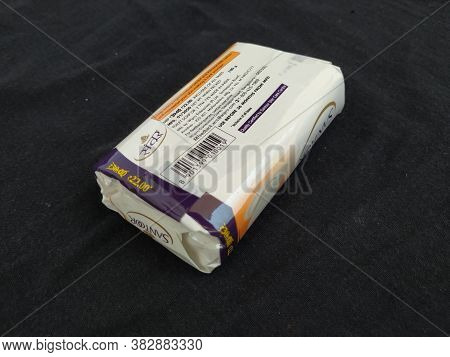 Closeup Of Pack Opened And Closed White Color Santoor Sandal And Almond Milk Soap Bar Isolated On Bl