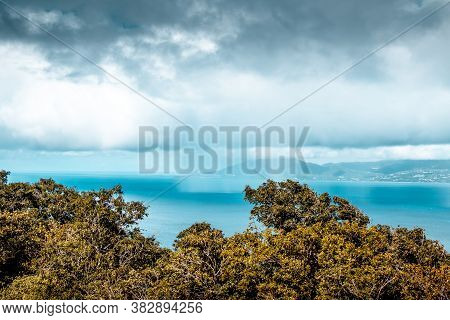 View Of The Bay Of Marigot On Guadeloupe With Clouds And Rain On The Ocean.