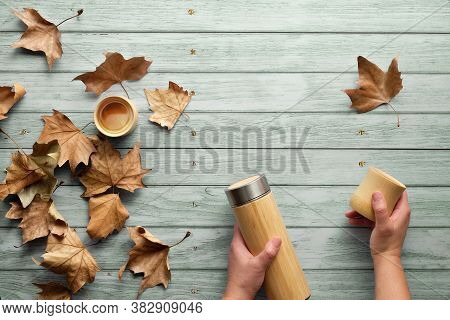 Zero Waste Eco Friendly Insulated Bamboo Flask With Bamboo Cups. Trendy Flat Lay With Hands Holding 