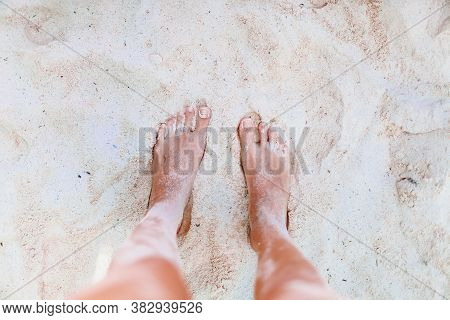 Young Woman Sunbathing On White Beach. Legs.