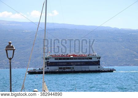 Lake Garda, Brescia,  Italy - 07/ 30/ 2020: An Old Paddle Steamer Boat On  Garda Lake