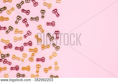 Phallus Shaped Pasta On Pink Paper Background, Penis Silhouette, Male Potency Concept. Sexual Health