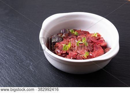 French Food Gesiers De Poulets Confits Sous Vide Chicken Gizzard Confit In White Ceramic Cup On Blac