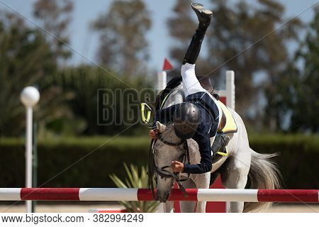 Horse Show Jumping Accident, Young Rider Falling From Horse During A Competition