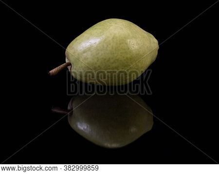 Green Ripe Pear On A Black Background. Bera Pear Variety, Large Fruits. Autumn Fruits.