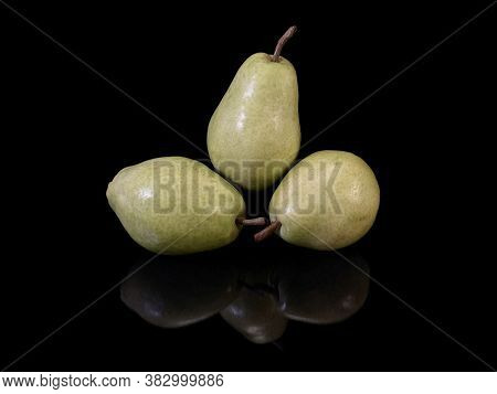 Green Ripe Pear On A Black Background. Bera Pear Variety, Large Fruits. Autumn Fruits.