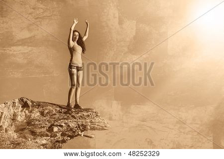 donna alta acrofobia sta in cima a bordo di una scogliera di roccia ed è